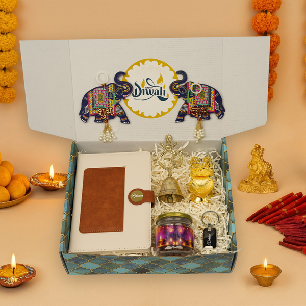 "Personalized Diwali Gift Hamper 2.0-WHITE “Dual Shade Diary, Metal Keychain, Om Brass Bell, Laxmi Ganesh Diya, Almond Jar & Shubh Labh Latkan – Festive Gift Box”